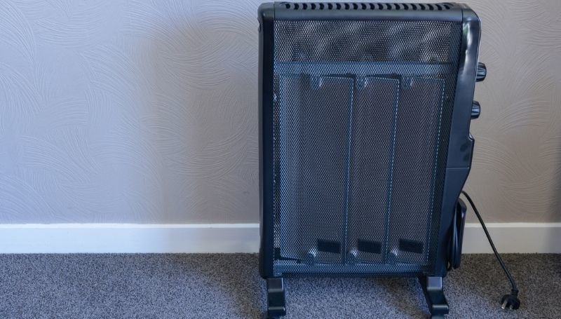 an unplugged all-black space heater on wheels